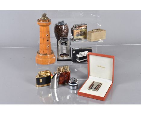 An ST Dupont pocket lighter, ref 05D 11A8 in original box, together with eight table lighters, including a Wooden Lighthouse 