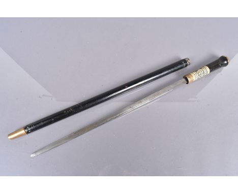 A short Middle Eastern sword stick, with ebonised shaft with carved design, brass lion head terminal to the top, twist lock, 