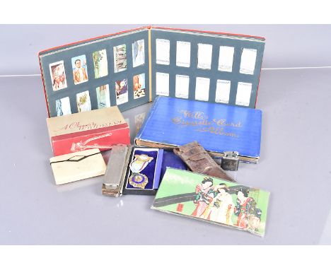 A collection of various items, comprising cigarette and trade cards, a silver R.O.A.B medallion, a Hohner harmonica, Burman h