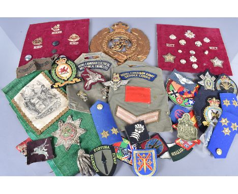 An assortment of military cloth badges, to include New Zealand Scottish, SAS, Monmouthshire, epaulettes, plus buttons, a vint