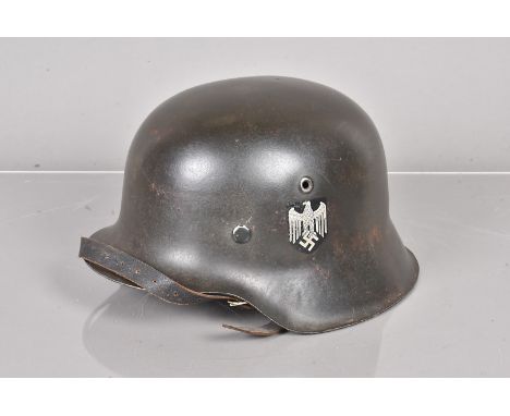A WWII period German M42 Heer single decal helmet, with Wehrmacht decal to the left, stamped kp64 and 4923 to the inner back,