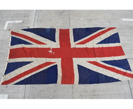A large early 20th Century Union Flag, possibly Naval, with numerous stamps including, 4** Jack, Broad Arrow mark with date, 