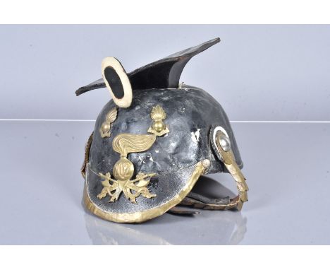 An Imperial German Uhlan helmet, with brass chin strap and leather liner, with applied brass helmet plate and two titles, wit