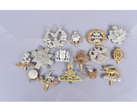 A small collection of cap badges, including Royal Malta Artillery, Army Education Corps, Indian Medical Service, South Lancas