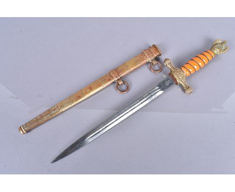 A German Kreigsmarine dagger by WKC, with orange grip with wound wire, maker's name to the blade, the double fullered 25cm lo