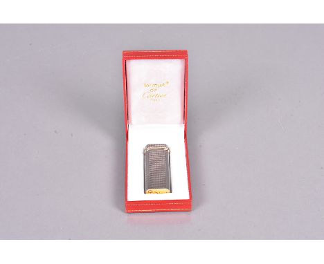 A Les Must de Cartier Pocket lighter, serial 40721T, with engine turned white metal body, with bi-metal decoration to the cov