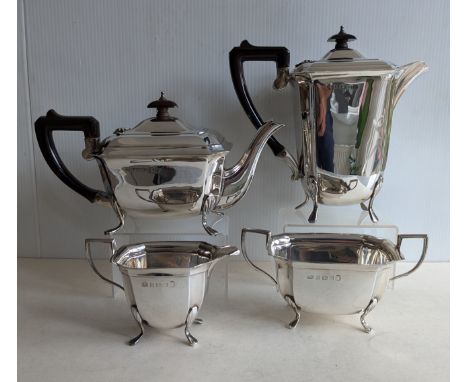 An Art Deco silver four-piece tea and coffee service with faceted decoration, ebonised handles on splayed feet, hallmarked fo