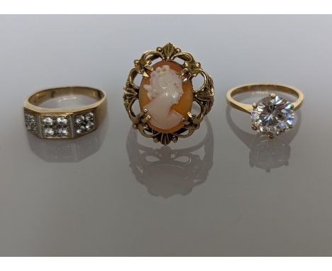 An oval cameo ring on an elaborately pierced, claw-set mount, stamped and tests for 14ct gold, size R, 5.45g and two cubic zi