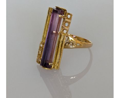 An amethyst dress ring in a yellow gold setting and diamond decoration, the faceted tubular amethyst 25mm, stamped 750, size 