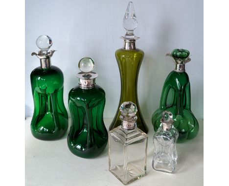 Three late Victorian/Edwardian green glass 'glug-glug' decanters with silver collars/pourers, hallmarked for Hukin & Heath, E