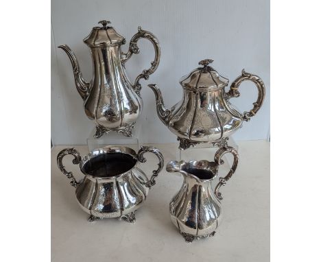 A Victorian silver four-piece tea and coffee service of baluster form with C-scroll embossed and etched decoration on applied