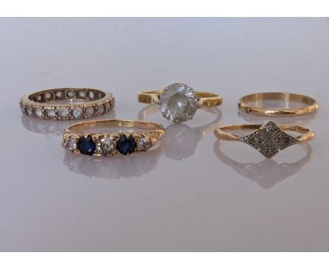 An early 20th century five-stone diamond and sapphire ring on a yellow gold setting with carved head; an Art Deco four-stone 