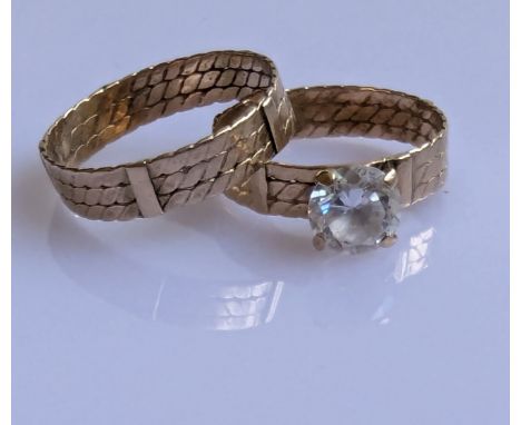 Two yellow gold wedding bands with carved decoration, one with a mounted cubic zirconia, size R, P, unmarked, but testing for