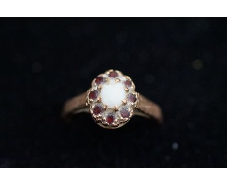 9ct Gold ring set with central Opal surround by garnets Size J