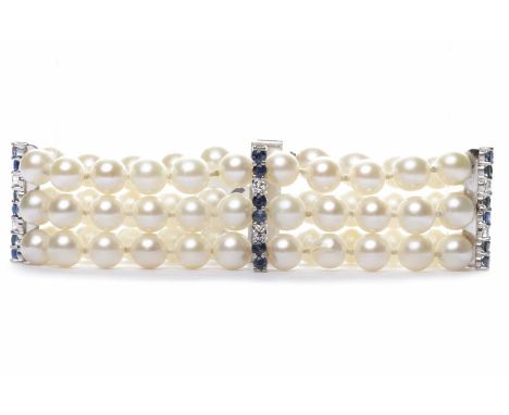 THREE STRANDED PEARL BRACELETformed by spherical white pearls each approximately 7.30mm diameter, with three diamond and blue