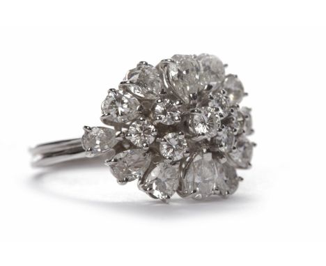 DIAMOND CLUSTER RINGthe oval bezel formed by separate claw set pear shaped and round brilliant cut diamonds, the diamonds tot