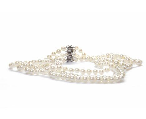 THREE STRANDED PEARL NECKLACEformed by white spherical pearls each 7.1mm diameter, with a pearl and diamond set clasp marked 