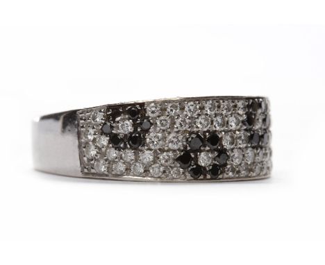 BLACK AND WHITE DIAMOND RINGthe broad tapered band 8mm at the widest point, with pave set white diamonds and with black diamo