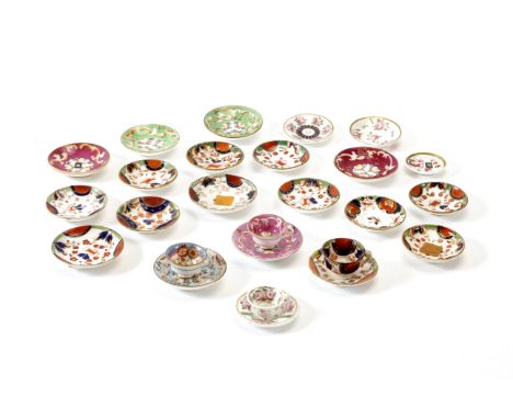 A GROUP OF MINIATURE TEA CUPS and saucers together with a further quantity of miniature saucers (a lot)