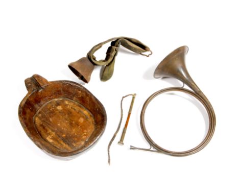 A LATE 19TH CENTURY COPPER HORN, a wooden dairy bowl, a metal cowbell, a leather strap and a mahogany and brass handled whip 