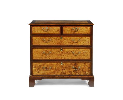 A GEORGE III BURR WALNUT AND MAHOGANY BANDED VENEERED CHEST of two short and three long drawers with gilt brass drop handles 