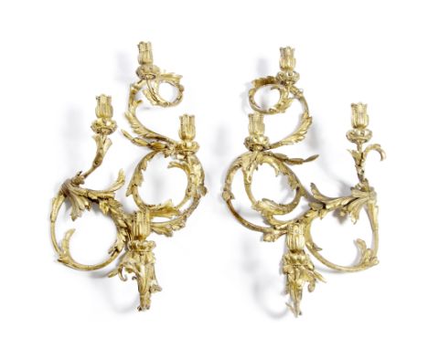 A PAIR OF GEORGE III GILT GESSO FOUR LIGHT CANDLE SCONCES with acanthus leaf moulded scrolling arms, 44cm wide x 77cm high (2