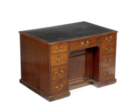 A GEORGE III MAHOGANY PARTNERS DESK with leather inset top having nine drawers to one side around a recessed cupboard and eig