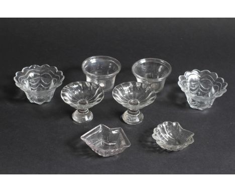 A PAIR OF ANTIQUE GLASS PATTY PANS with folded rims 7cm diameter, a pair of footed patch stands (?), two cut glass salts and 