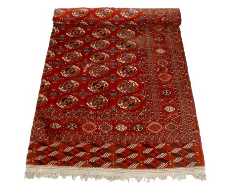 A TEKKE TURKMEN RED GROUND SMALL CARPET with central geometric decoration within a typical border, 370cm long x 314cm wide 