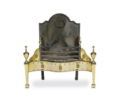 A GEORGE III BRASS AND CAST IRON FIRE GRATE the back with arching shaped top and cast shell decoration, the bowed front with 