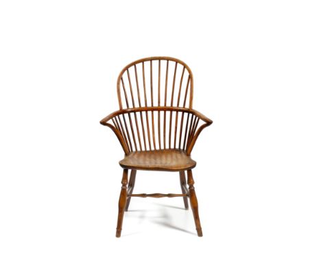 A 19TH CENTURY YEW AND ELM WINDSOR HIGH STICK BACK ARMCHAIR with carved saddle seat, on turned legs united by a turned H stre