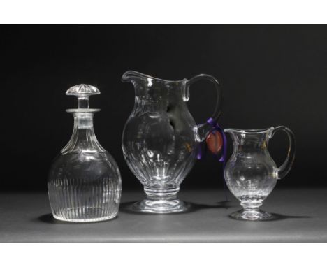 A CONTEMPORARY WILLIAM YEOWARD CUT GLASS JUG with looping handle and circular spreading base 25.5cm high together with a smal
