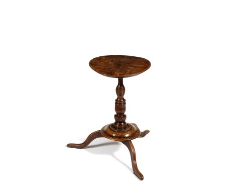 AN EARLY 18TH CENTURY WALNUT LAMP TABLE, the circular top on a turned column support and with turned spreading platform base 