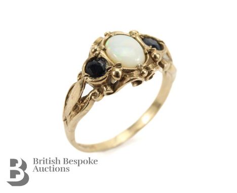 Vintage 9ct gold opal and sapphire ring, size P, approx 4 gms. The opal measuring 7 x 5mm flanked by two midnight blue sapphi