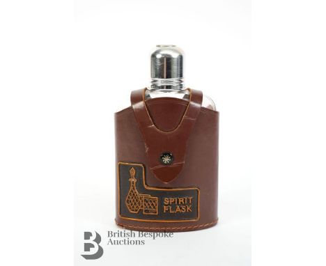 A spirit flask in leather case, with Triumph logo to drinks cap. Measures approx. 16cms.