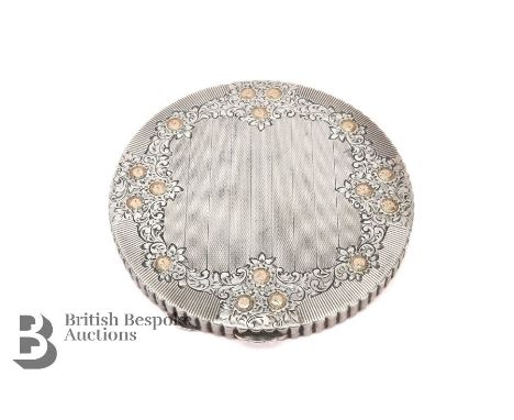 Art Deco silver circular mirrored compact, engine-turned with floral engraving heightened with 9ct gold, approx 9.5 cms, with