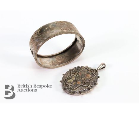 Victorian oval silver locket heightened with 9ct gold, 45 x 35 mm together with an antique silver bangle engraved with a bird
