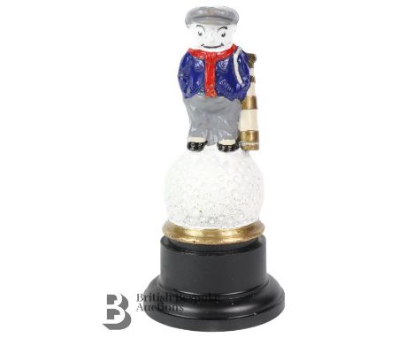 A brass Dunlop golfer accessory mascot, painted in 5 colours, reads Dunlop 31 on front and back of the golf ball. Measures ap