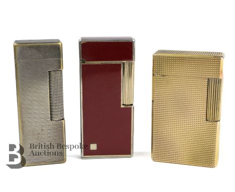 Three vintage lighters, SJ Dupont Paris gold plated example, Dunhill American Patent lighter and a red-finished Rowenta light