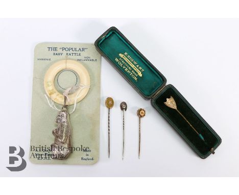 Four tie pins, including one boxed gold shield example (possibly a gold plated pin) together with a vintage 'The Popular' bab