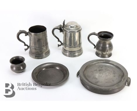 Vintage pewter, including two glass bottomed tankards, beaker, pint tankard, hot water plate and a side dish.&nbsp;