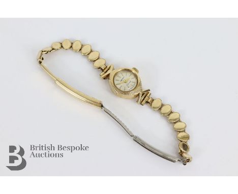 9ct gold lady's Rotary wrist watch, the watch having a champagne face with Arabic dial, weight without movement 1.3 gms, on a