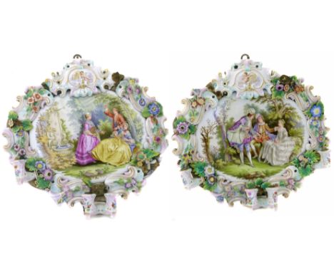 A pair od Rococo style ceramic wall plaques with candle sconces We are unable to do condition reports for this sale.