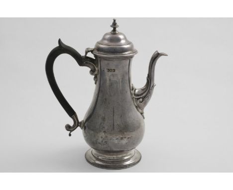 A LATE VICTORIAN BALUSTER COFFEE POT with a domed cover, knop finial and a spreading circular foot, the spout with a leaf wra