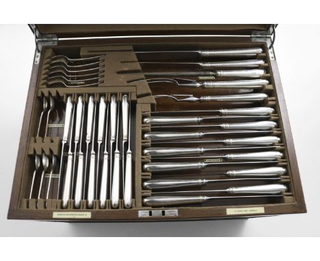 A CANTEEN OF OLD ENGLISH PATTERN FLATWARE &amp; CUTLERY (and condiments) in a 3-drawer walnut cabinet with lift-up cover to i