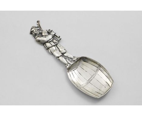 A CONTINENTAL NOVELTY CADDY SPOON in the form of a bagpiper standing on top of a barrel, with pseudo marks and English import