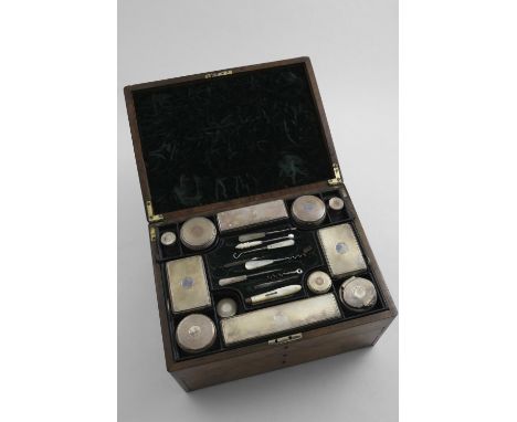 A WILLIAM IV WALNUT TOILET BOX fitted with mounted cut-glass bottles &amp; jars, the covers decorated with engine-turning and