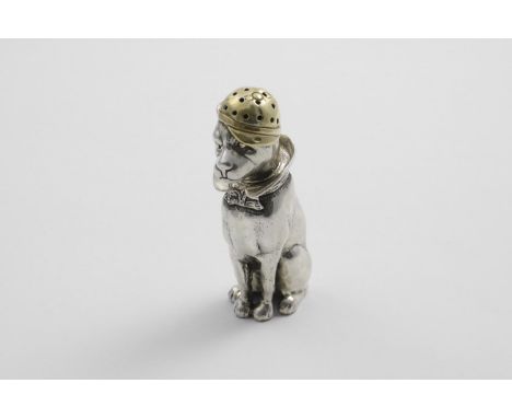 A CONTEMPORARY PARCELGILT CAST NOVELTY PEPPER CASTER in the form of a dog, sitting upright and wearing a hat and a collar sec