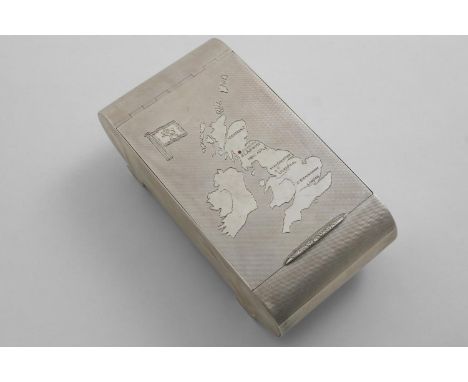 AN ART DECO CIGARETTE BOX of rounded oblong form with two tubular feet and engine-turned decoration, the cover engraved with 