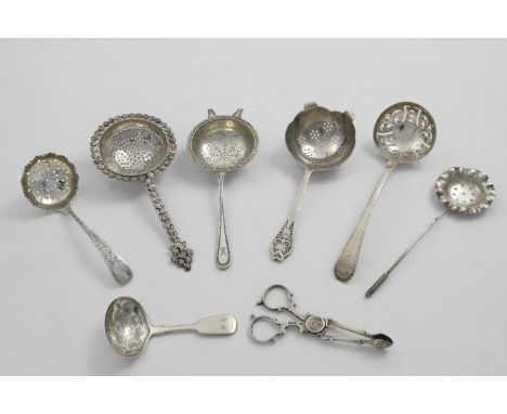 A MIXED LOT:- Two tea strainers, an Indian tea strainer, three sugar sifter spoons, a pair of sugar nips and a William IV cad